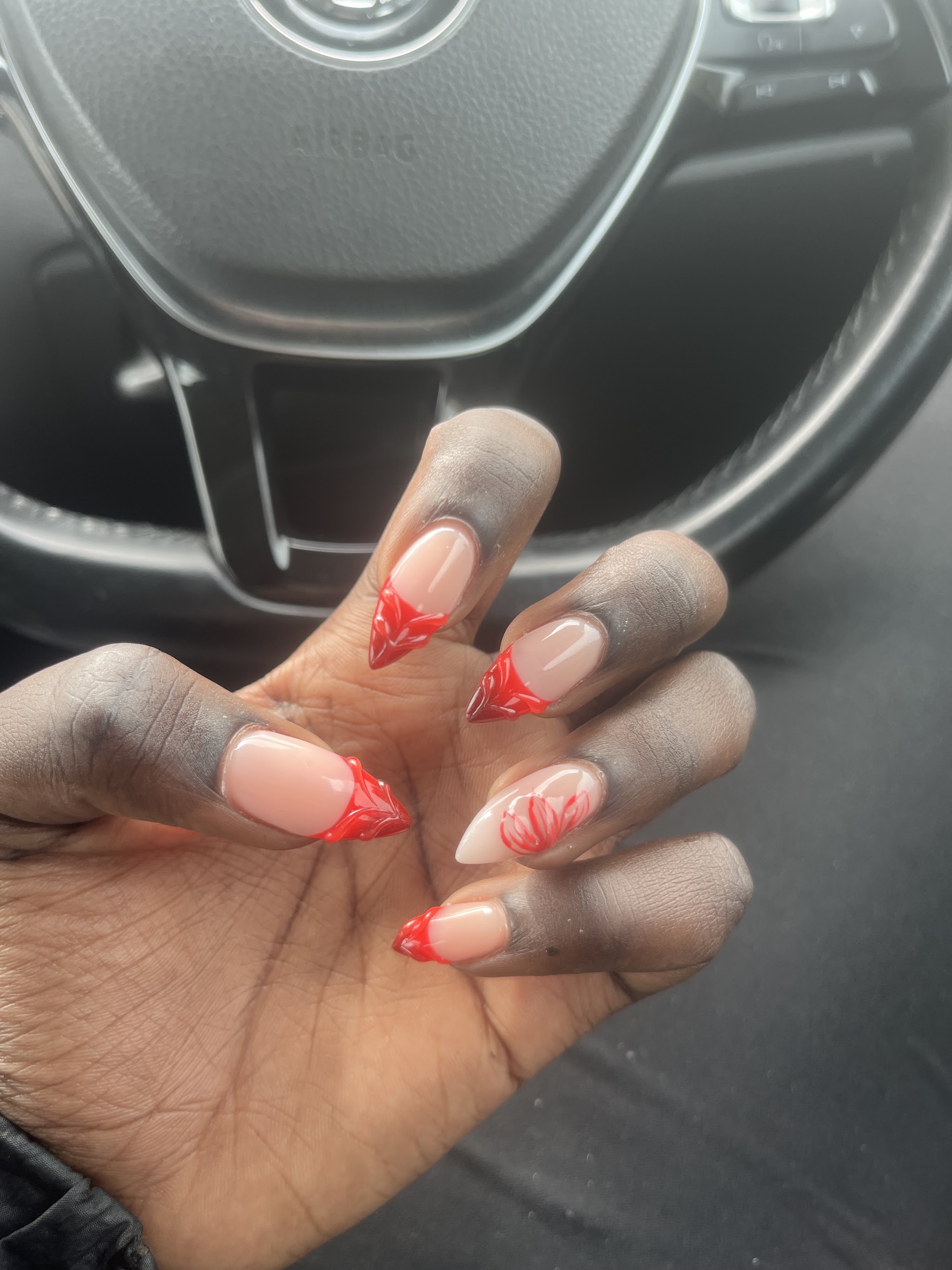 Red French tips with a hand painted floral accent nail