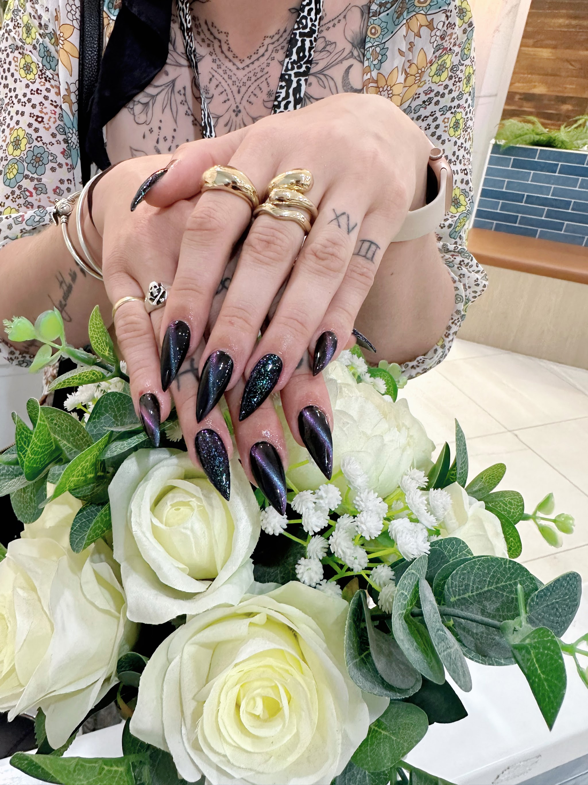 Chrome black stiletto nails with a holographic shift