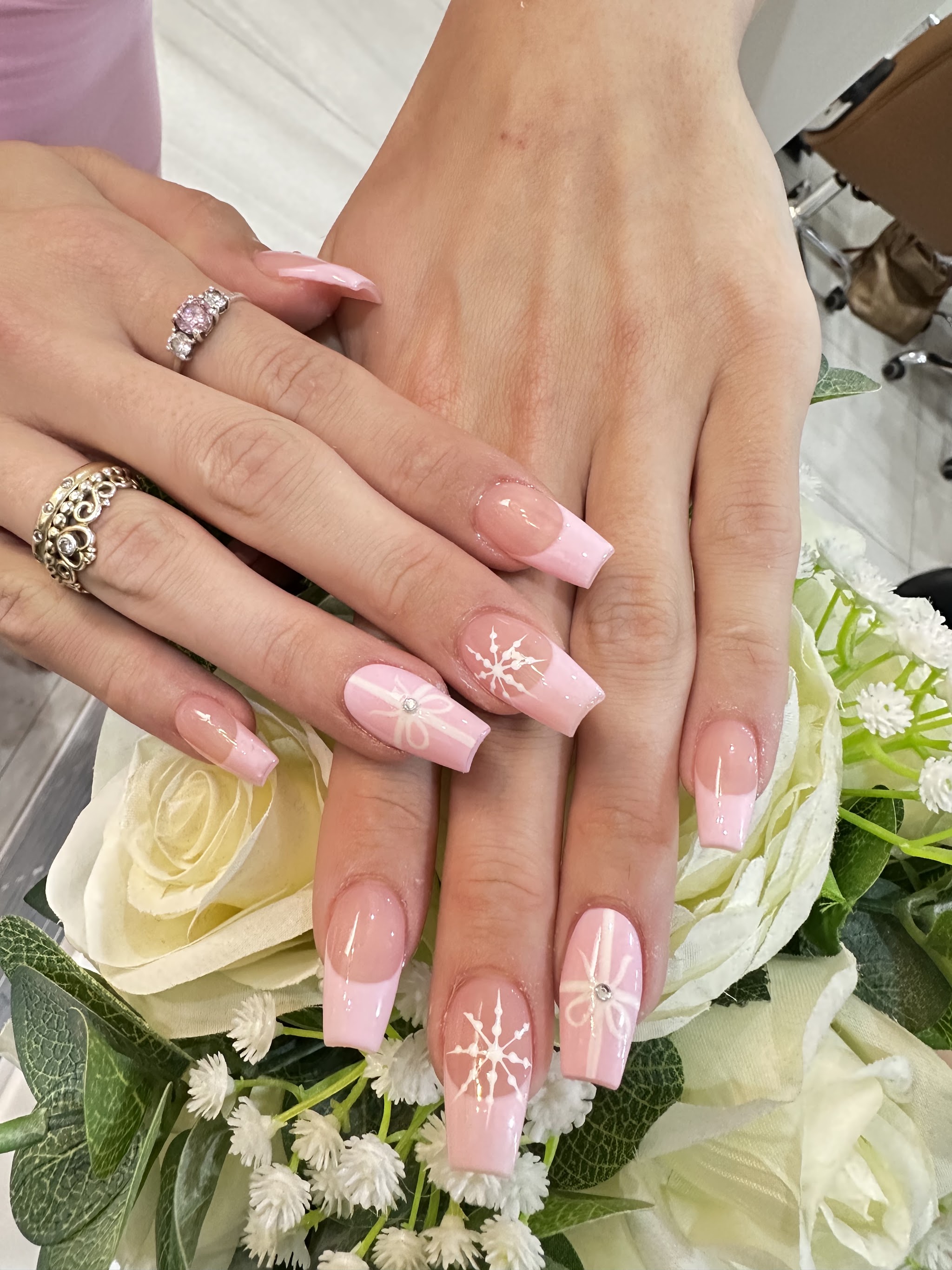 Baby pink coffin nails with rhinestones and fine line art